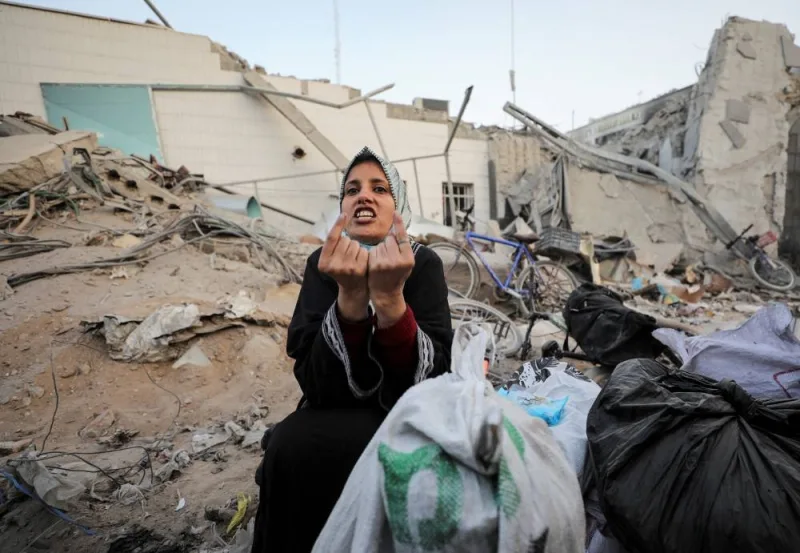 A woman reacts as she inspects damages at Al Shifa Hospital after Israeli forces withdrew from the hospital and the area around it. REUTERS