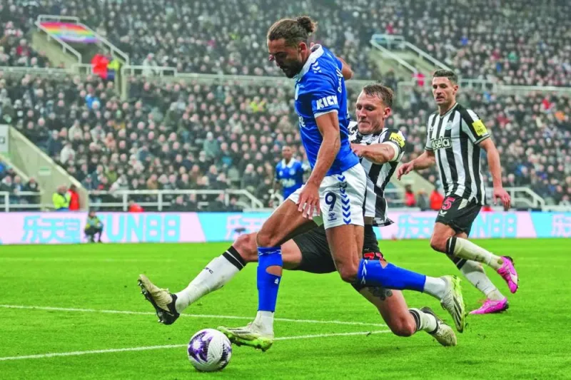 Everton’s Dominic Calvert-Lewin (left) vies for the ball with Newcastle United’s Dan Burn during Premier League match at St James’ Park in Newcastle on Tuesday. (AFP)