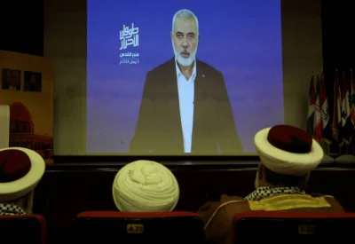 Hamas chief Ismail Haniyeh speaks in a pre-recorded message shown on a screen during an event on Wednesday ahead of al-Quds (Jerusalem) Day on Friday April 5, in Lebanon. REUTERS