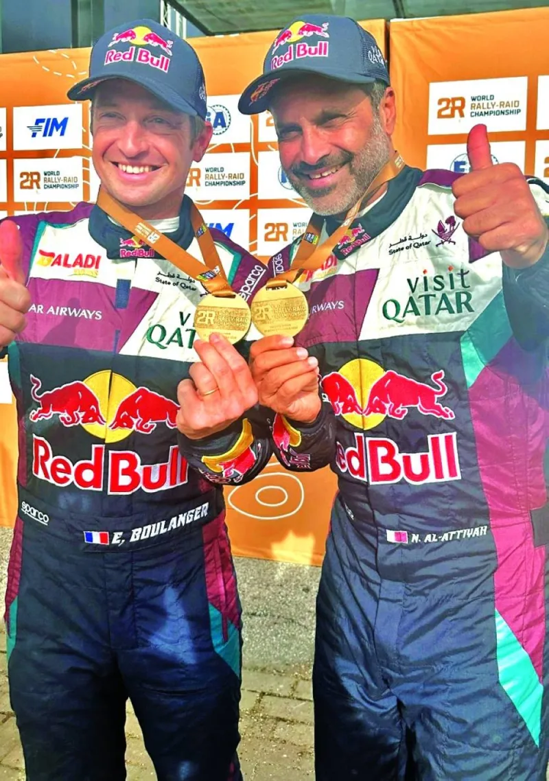 Nasser Saleh al-Attiyah and his co-driver Edouard Boulanger (left) pose with their medals after winning the second stage at the Rally-Raid Portugal on Thursday.