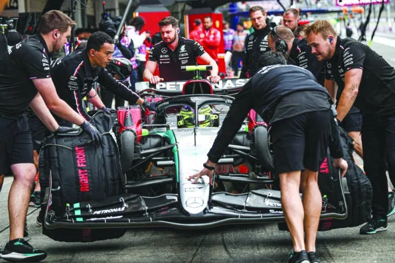 Mechanics push the car of Mercedes’ British driver Lewis Hamilton during the second practice session ahead of the Japanese Grand Prix race at the Suzuka Circuit on Friday. (AFP)