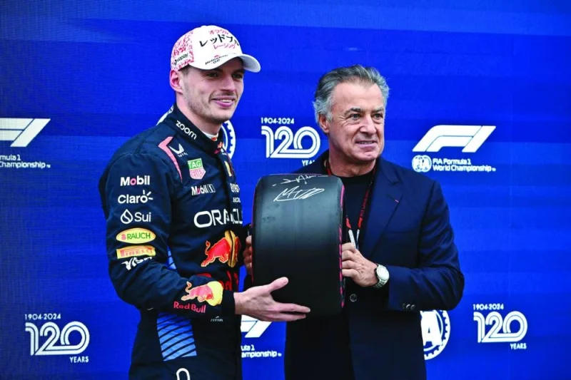 Pole position qualifier Red Bull Racing’s Dutch driver Max Verstappen (left) poses with former French F1 driver Jean Alesi after the qualifying session for the Formula One Japanese Grand Prix race at the Suzuka circuit in Suzuka, Mie prefecture, on Saturday. (AFP)