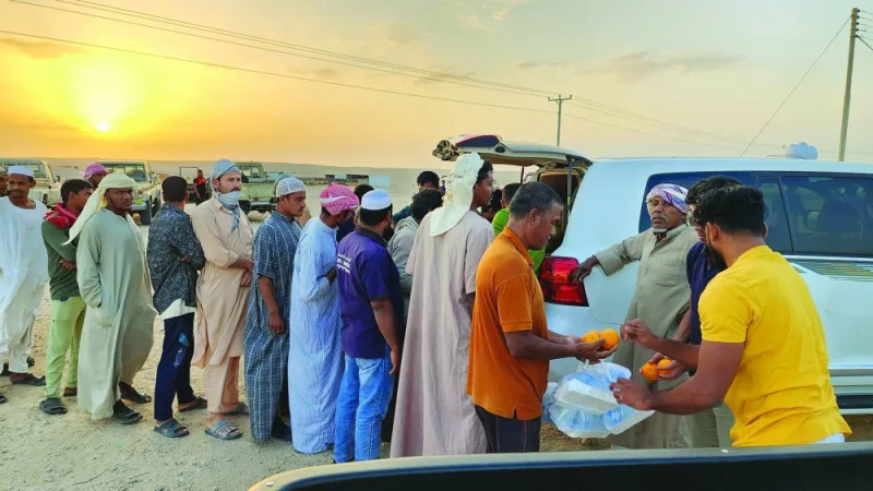 Iftar kit distribution at a desert location.