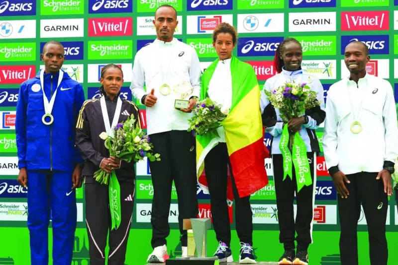 
Men’s marathon winners, second-placed Titus Ekiru of Kenya (left), winner Uma Mulugeta of Ethiopia (centre, left) and third-placed Elisha Rotich of Kenya (right), pose with women’s marathon winners, second-placed Enat Tirusew of Ethiopia (second left), winner Mestawut Fikir of Ethiopia (centre right ) and third-placed Vivian Cheruiyot of Kenya (second-right) on the podium at the end of the 2024 Paris Marathon, in Paris, yesterday. (AFP) 