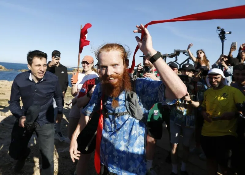 Britain&#039;s Russ Cook reacts after becoming the first person to run the entire length of Africa. REUTERS