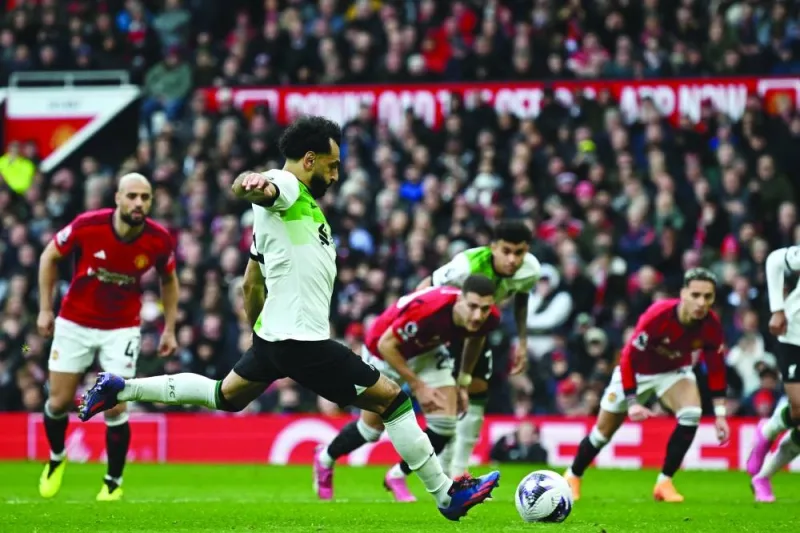 
Liverpool’s Mohamed Salah scores their second goal from the penalty spot during the English Premier League match against Manchester United at Old Trafford in Manchester yesterday. (AFP) 
