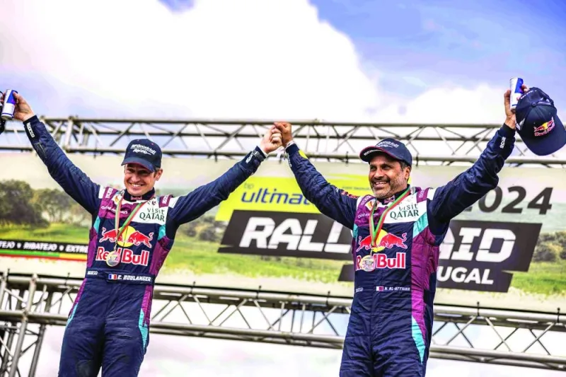 
Qatar’s Nasser Saleh al-Attiyah (right) and his co-driver Edouard Boulanger celebrate on the podium after winning the Ultimate Rally-Raid Portugal in Grandola, Portugal, yesterday. 