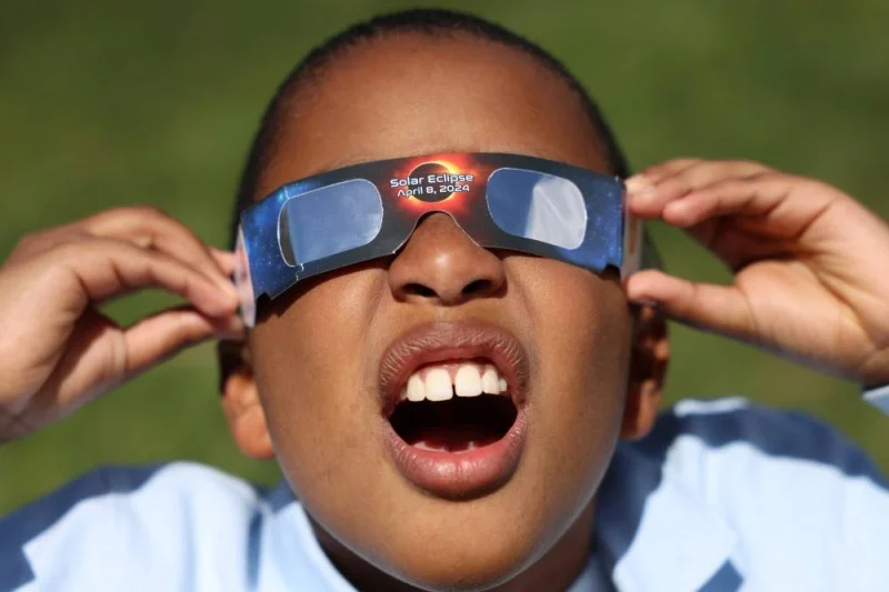Adrian Plaza, 9, of Queens, tests his eclipse glasses ahead of a partial solar eclipse, where the moon will partially blot out the sun, at New York Hall of Science in Queens borough, New York City, Monday. REUTERS