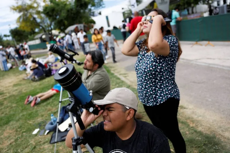 People gather as they prepare to observe the solar eclipse, in Torreon, state of Coahuila, Mexico, Monday. REUTERS