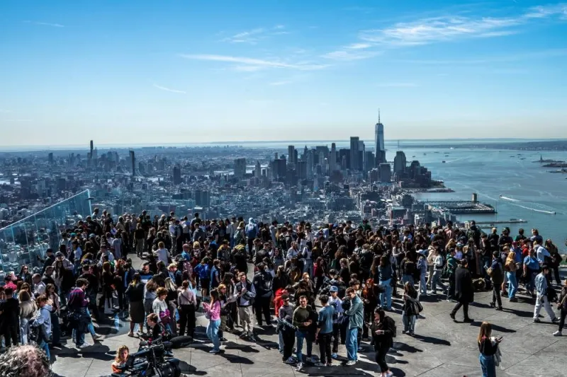 People gather on the observation deck of Edge at Hudson Yards before a partial solar eclipse in New York City, Monday. REUTERS