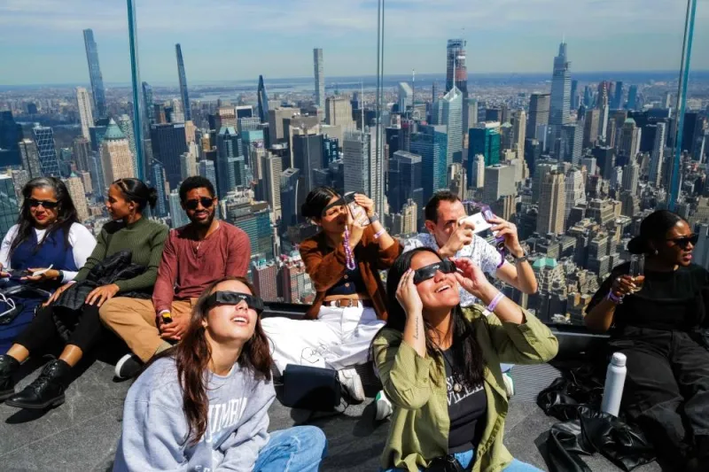 People look toward the sky at the &#039;Edge at Hudson Yards&#039; observation deck ahead of a total solar eclipse across North America, in New York City on Monday. AFP