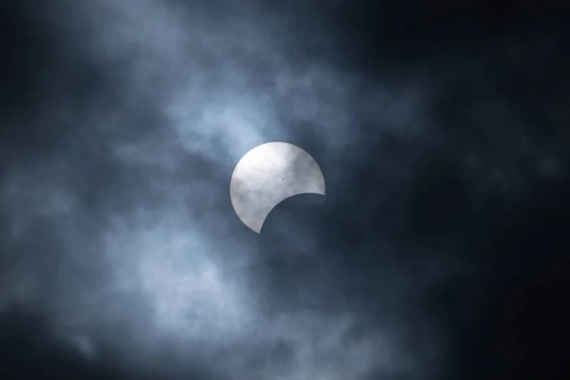 The partial Solar Eclipse is seen through clouds on Monday in Niagara Falls, New York. AFP