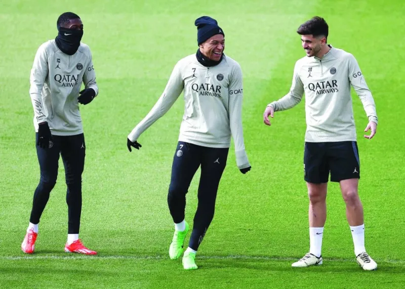Paris Saint-Germain’s Ousmane Dembele (left), Kylian Mbappe (centre) and Lucas Beraldo during a training session in Paris on Tuesday, on the eve of their UEFA champions league quarter-final first leg match against Barcelona. (AFP)