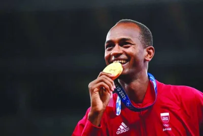 
Qatar’s Mutaz Barshim poses with the gold medal after winning the high jump event at the Tokyo Olympic Games on August 1, 2021. 
