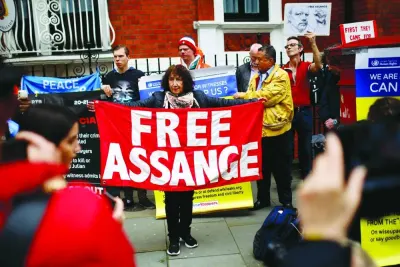 Supporters of WikiLeaks founder Julian Assange display banners at a demonstration outside the Ecuadorian embassy in London on Thursday, on the fifth anniversary of the arrest of Julian Assange by British police at the embassy.