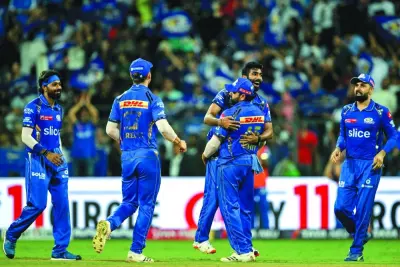 Mumbai Indians’ Jasprit Bumrah celebrates with his teammates after taking the wicket of Royal Challengers Bengaluru’s Vijaykumar Vyshak during the IPL match at the Wankhede Stadium in Mumbai on Thursday. (AFP)