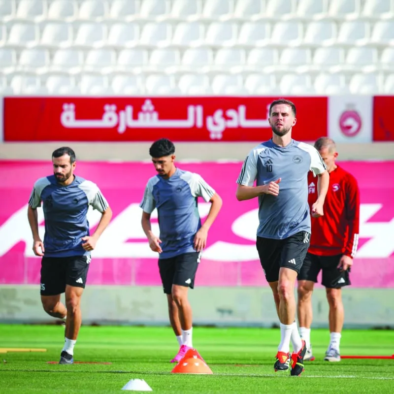 
Sharjah FC players warm up during a training session. 