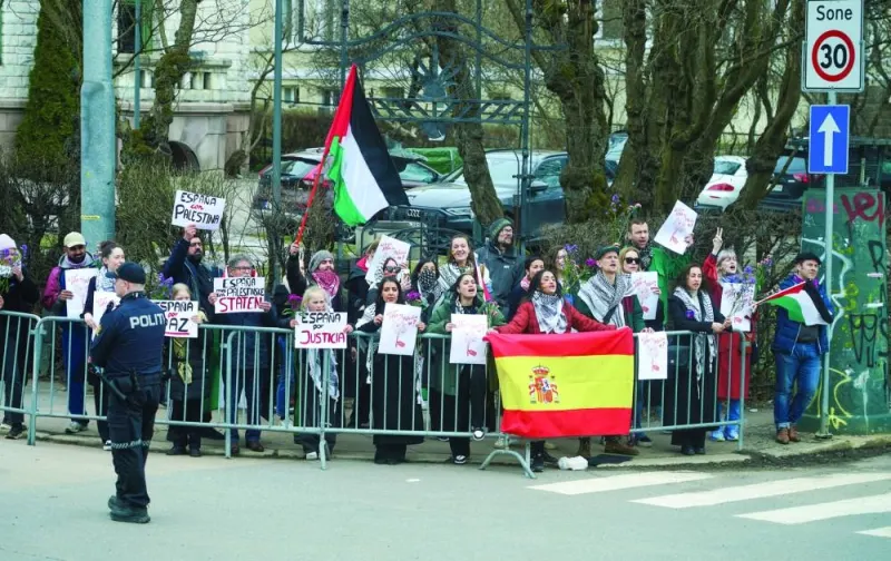 Demonstrators hold Spanish and Palestinian flags on the day of a bilateral meeting between Norwegian Prime Minister Jonas Gahr Store and Spanish Prime Minister Pedro Sanchez, outside the government’s representation facility in Oslo, Norway, on Friday.