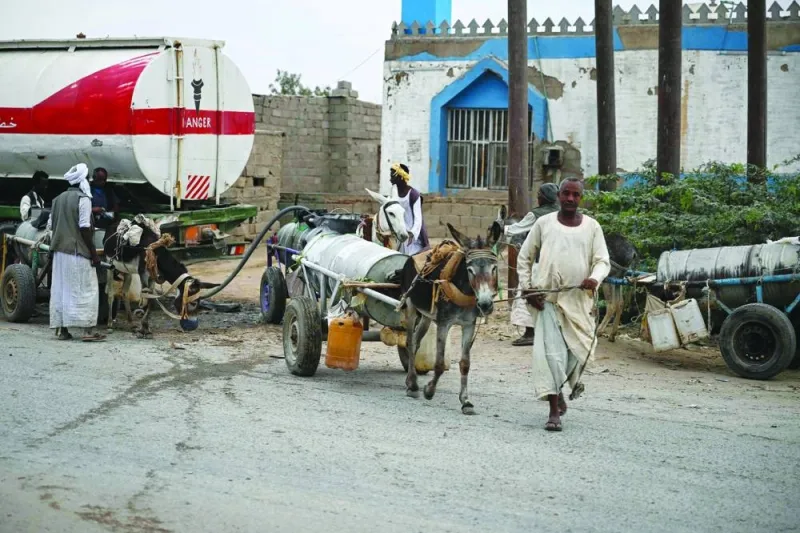 
People refill donkey-drawn water tanks during a water crisis in Port Sudan in the Red Sea State of war-torn Sudan. 