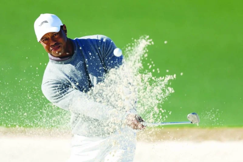 Tiger Woods of the United States plays a shot from a bunker on the 18th hole during the continuation of the first round of the 2024 Masters Tournament in Augusta, Georgia, on Friday. (AFP)