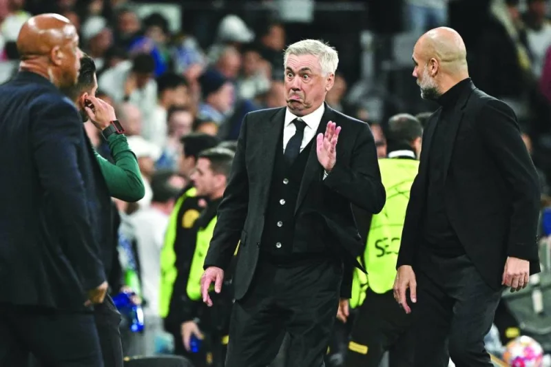 Real Madrid&#039;s Italian coach Carlo Ancelotti (centre) gestures next to Manchester City&#039;s Spanish manager Pep Guardiola (right) during the UEFA Champions League quarter final first leg football match between Real Madrid CF and Manchester City at the Santiago Bernabeu stadium in Madrid, recently. (AFP)