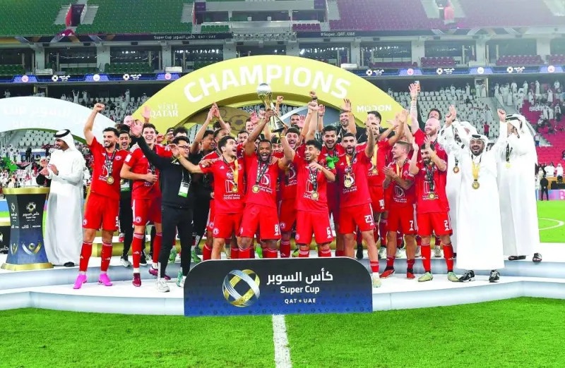 Al Arabi players and officials celebrate after winning the inaugural Qatar-UAE Super Cup at the Al Thumama Stadium on Friday. PICTURES: Noushad Thekkayil