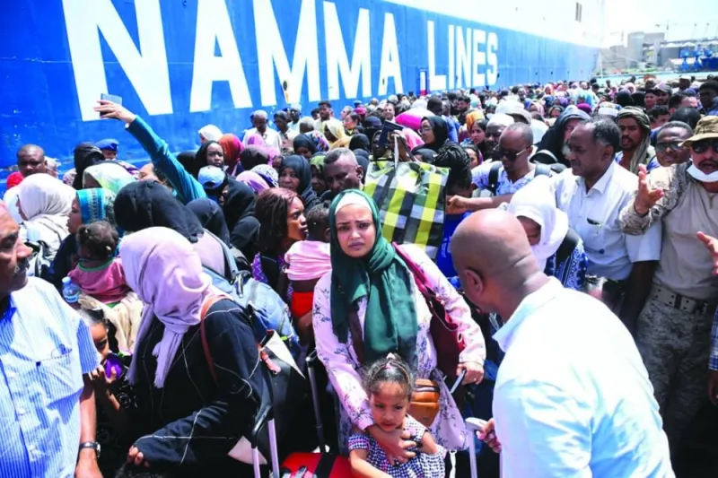 File photo shows people fleeing war-torn Sudan queue to board a boat from Port Sudan, amid the ongoing conflict in the country.