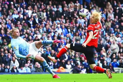 Manchester City’s Erling Haaland (left) sees his shot deflected into the net by Luton Town’s Daiki Hashioka for an own goal during the Premier League match at the Etihad Stadium in Manchester on Saturday. (AFP)