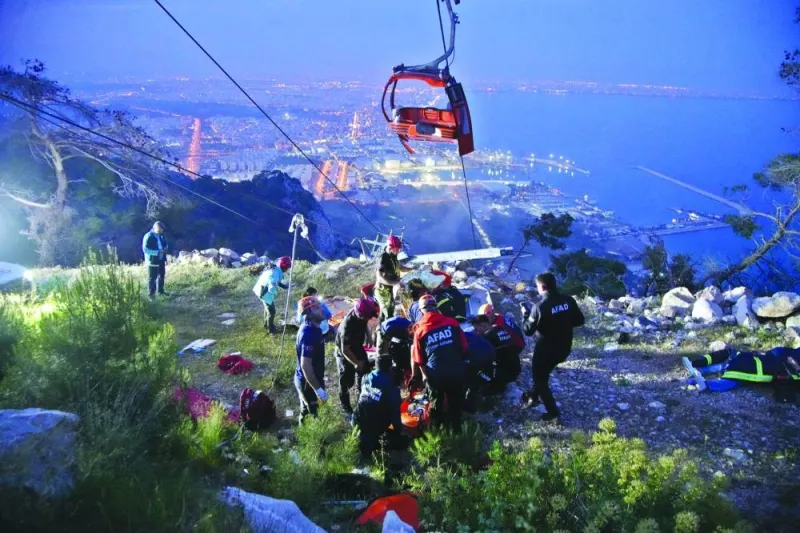
Members of Turkiye’s Disaster Management Authority (AFAD) take part in a rescue operation after a cable car cabin collided with a broken pole, in Antalya. 