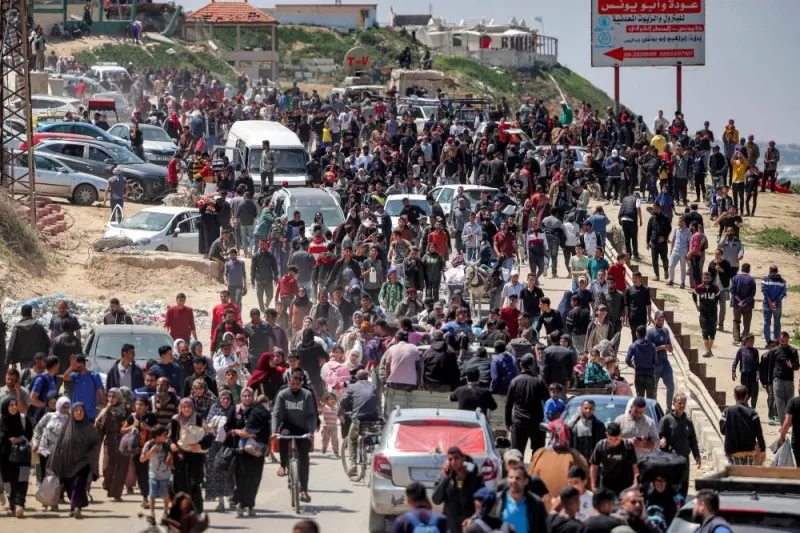 Displaced Palestinians take the coastal Rashid road to return to Gaza City as they pass through Nuseirat in the central Gaza Strip on Sunday. AFP