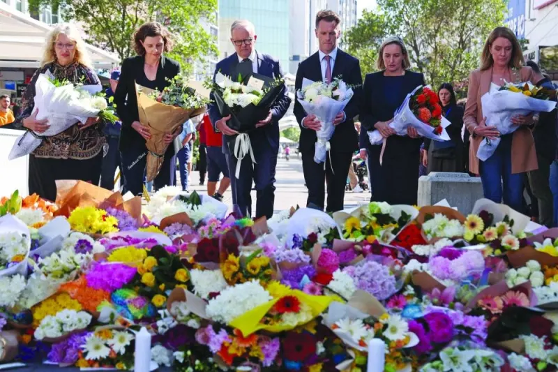 
Australian Prime Minister Anthony Albanese (centre) stands with New South Wales Premier Chris Minns (fourth right) and other officials as they prepare to leave flowers outside the Westfield Bondi Junction shopping mall in Sydney yesterday. 