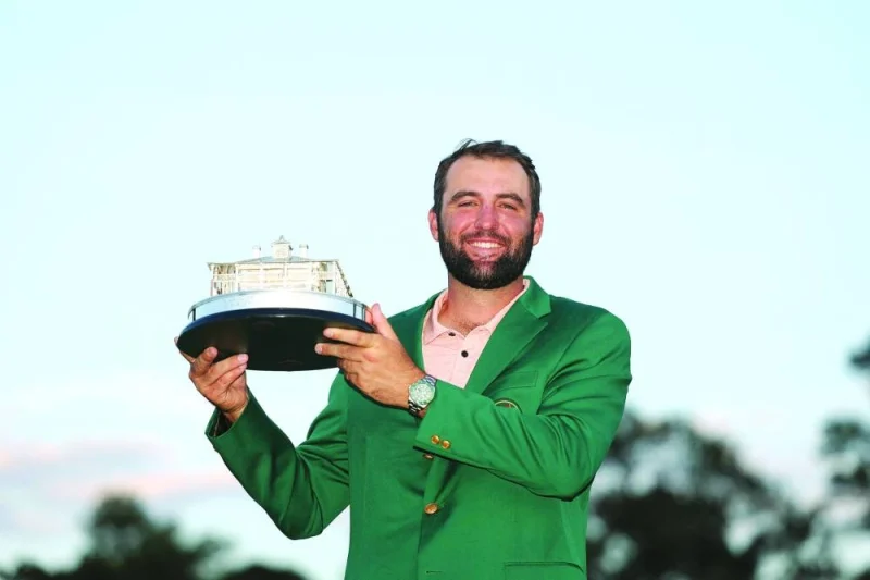 
Scottie Scheffler of the US poses with the trophy after winning the 2024 Masters at Augusta National Golf Club in Augusta, Georgia. Right: Scheffler is presented with the Green Jacket by last year’s winner Spain’s Jon Rahm. (AFP/Reuters)  