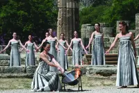 Greek actress Mary Mina, playing the role of the High Priestess, lights the torch during the rehearsal of the flame lighting ceremony for the Paris 2024 Olympics Games at the ancient temple of Hera on the Olympia archaeological site, birthplace of the ancient Olympics in southern Greece, on Monday. (AFP)