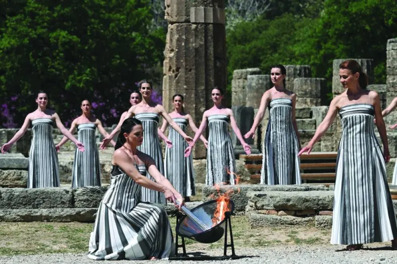 Greek actress Mary Mina, playing the role of the High Priestess, lights the torch during the rehearsal of the flame lighting ceremony for the Paris 2024 Olympics Games at the ancient temple of Hera on the Olympia archaeological site, birthplace of the ancient Olympics in southern Greece, on Monday. (AFP)