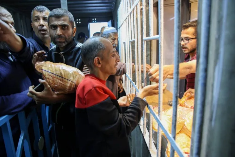 Displaced Palestinians line up to buy subsidised bread from a bakery in Gaza City on Sunday. AFP