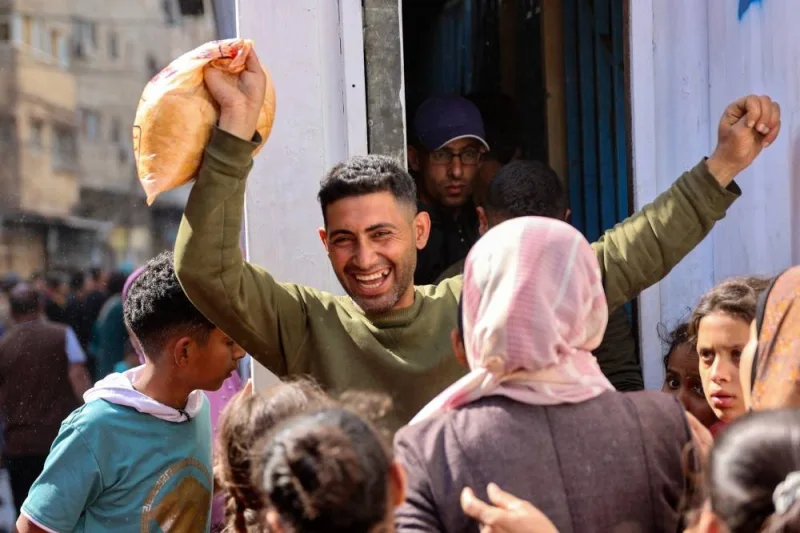 A Palestinian man reacts after buying subsidised bread outside a bakery in Gaza City on Sunday. AFP