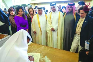 Guests and officials watch a Qatari artist at work during the special celebration organised by Qatar&#039;s Ministry of Culture at the Unesco headquarters in Paris.