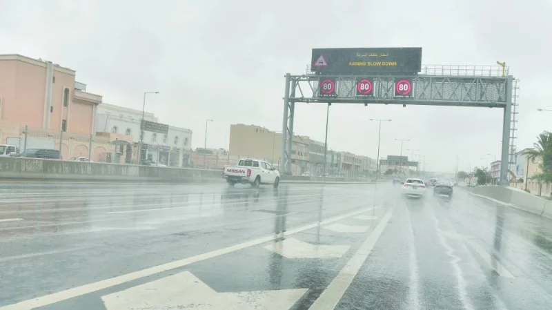 A message board on a Doha road, displaying rain warning from Ashghal, urging motorists to slow down. PICTURE: Shaji Kayamkulam.