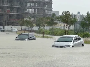 Cars drive through a flooded street during a rain storm in Dubai, Tuesday.