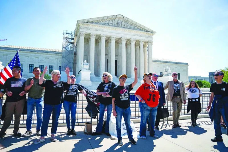 
Supporters of defendants including Micki Witthoeft, the mother of Ashli Babbitt, who was killed on January 6, 2021, sing outside the Supreme Court in Washington, DC, yesterday. 