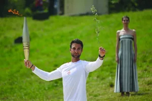 
Rowing Olympic gold medalist Stephanos Ntouskos holds the Olympic torch following the flame lighting ceremony for the Paris 2024 Games at the Ancient Olympia archeological site in Greece yesterday. (AFP) 