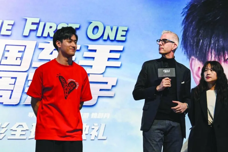 
Formula 1 Kick Sauber’s Chinese driver Zhou Guanyu (left) and Managing Director of Sauber Group and representative of the Alfa Romeo F1 Team, Alessandro Alunni (centre) attend the world premier of the docu-film The First One, in Shanghai, yesterday. (AFP) 