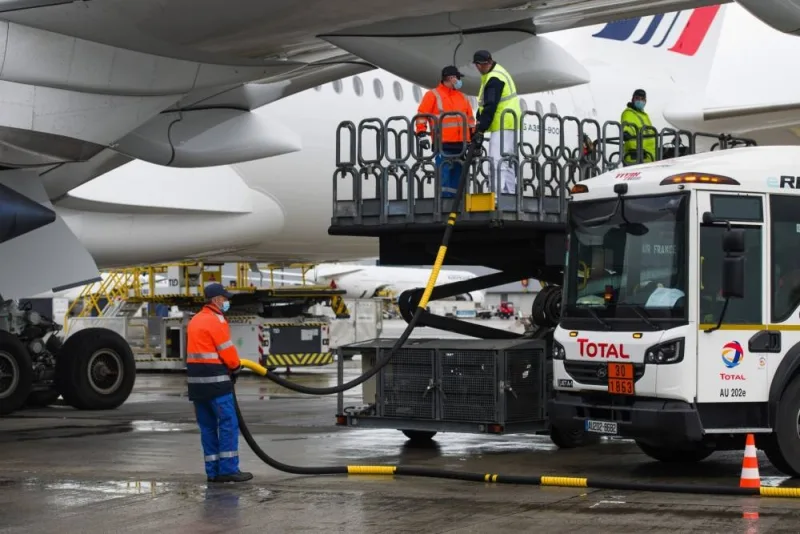Workers connect a Total tanker truck to an Airbus A350 passenger plane, during fuelling with sustainable aviation fuel, at Charles de Gaulle airport in Roissy, France. All roadmaps assume that sustainable aviation fuels will be responsible for the greatest amount of CO2 reductions by 2050, according to a high-level joint review.