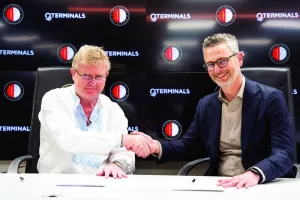 Neville Bissett, QTerminals group chief executive officer (L), and Ruud van der Knaap, Feyenoord’s CCO ink pact