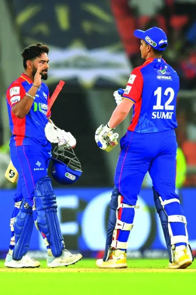 Delhi Capitals’ captain Rishabh Pant (left) celebrates with teammate after their win at the end of Indian Premier League (IPL) Twenty20 match against Gujarat Titans in Ahmedabad on Wednesday. (AFP)