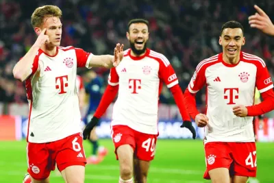 Bayern Munich’s German midfielder Joshua Kimmich (left) celebrates with teammates after scoring against Arsenal during the UEFA Champions League quarter-final second leg match in Munich on Wednesday. (AFP)