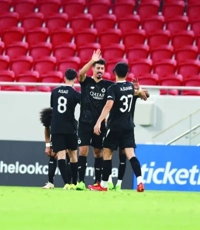 Al Sadd’s Baghdad Bounedjah celebrates with teammates after scoring a hat-trick against Al Ahli at the Al Thumama Stadium on Wednesday.