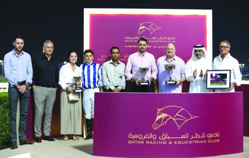 Connections of Fayq Al Shahania celebrate after the five year-old horse won the Msheireb Cup at the Al Rayyan Racecourse on Thursday. PICTURES: Juhaim