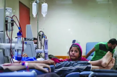 
File photo shows a girl sitting among patients in the kidney dialysis area at the Al-Aqsa Martyrs Hospital in Deir el-Balah, central Gaza Strip, amid the ongoing conflict between Israel and the Palestinian Hamas group. 