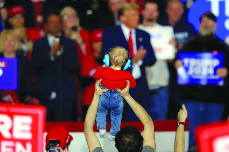A supporter of Donald Trump holds up a child during a campaign rally in Green Bay, Wisconsin.  (Reuters)